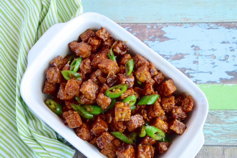 Cooked Tempeh in a dish with green chili soy sauce
