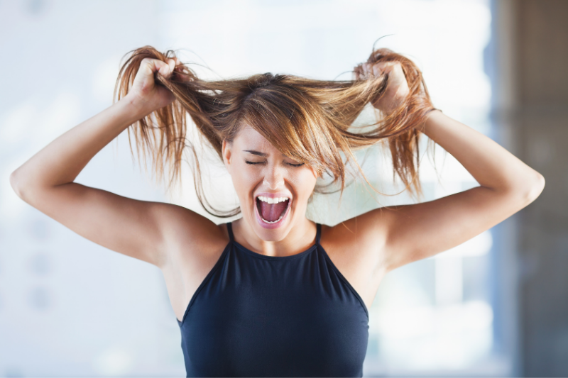 stressed woman grabbing hair