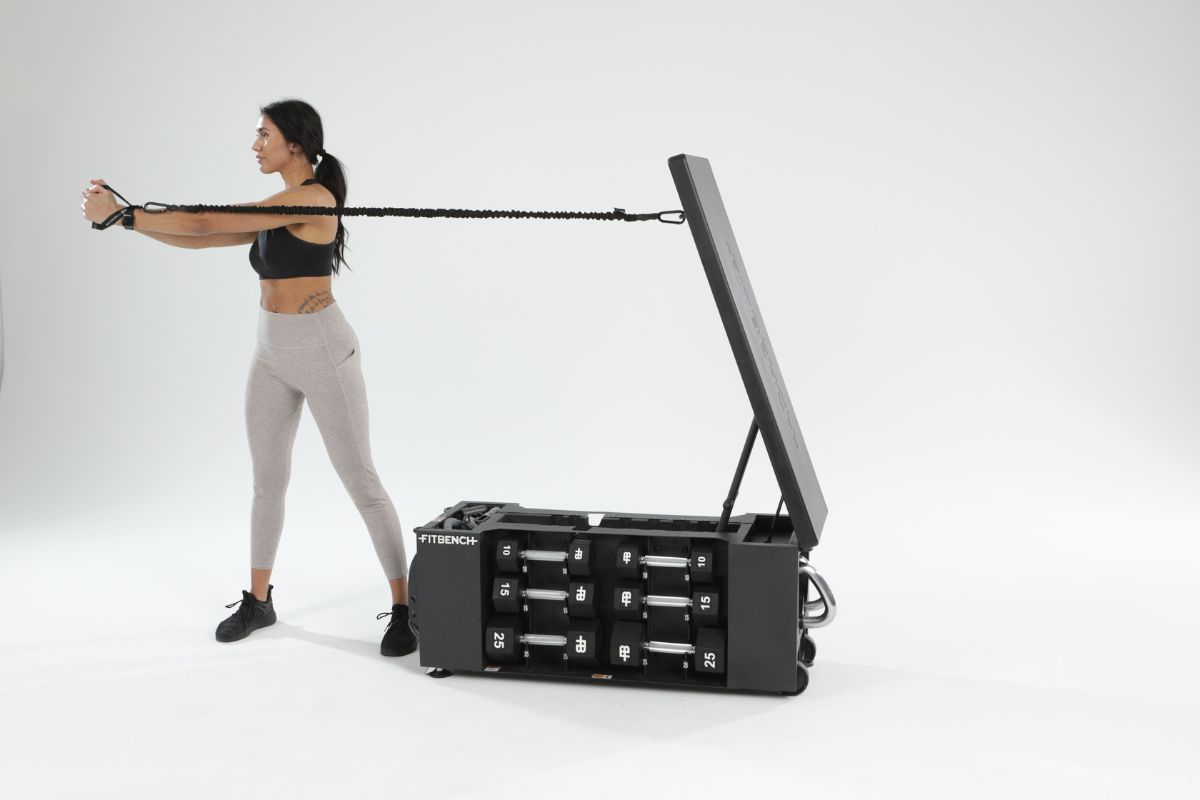 Woman using the FITBAND with the FITBENCH