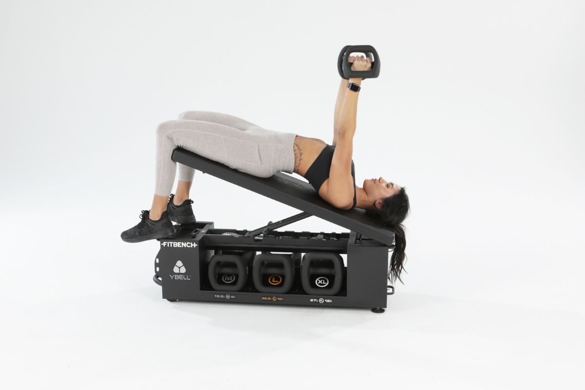 Woman using YBell on the FITBENCH