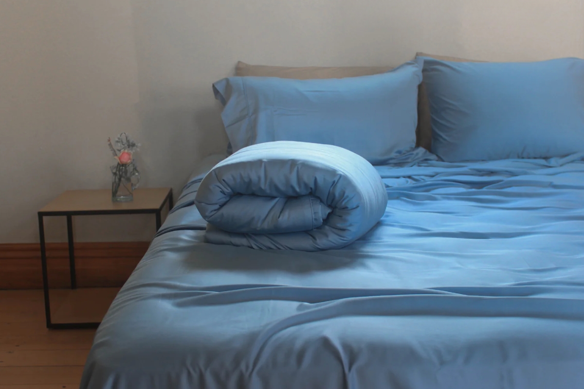 Groundd Weighted Blanket in a bed in Powder Blue colour