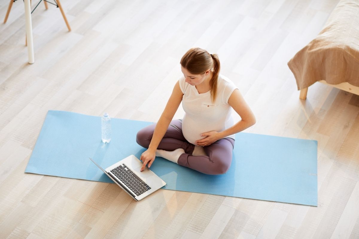 Pregnant woman on yoga mat