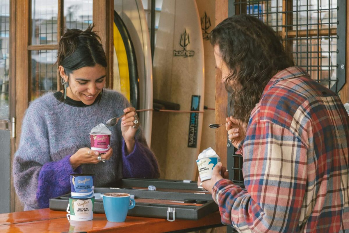 Man and woman sittign together eating Raglan Food Co Snackable coconut yoghurt