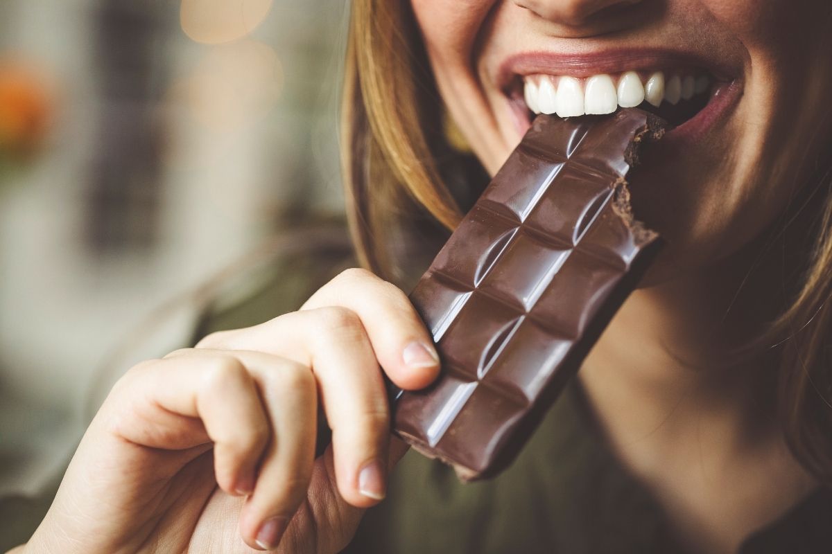 Nutrition with menstrual cycle woman eating chocolate