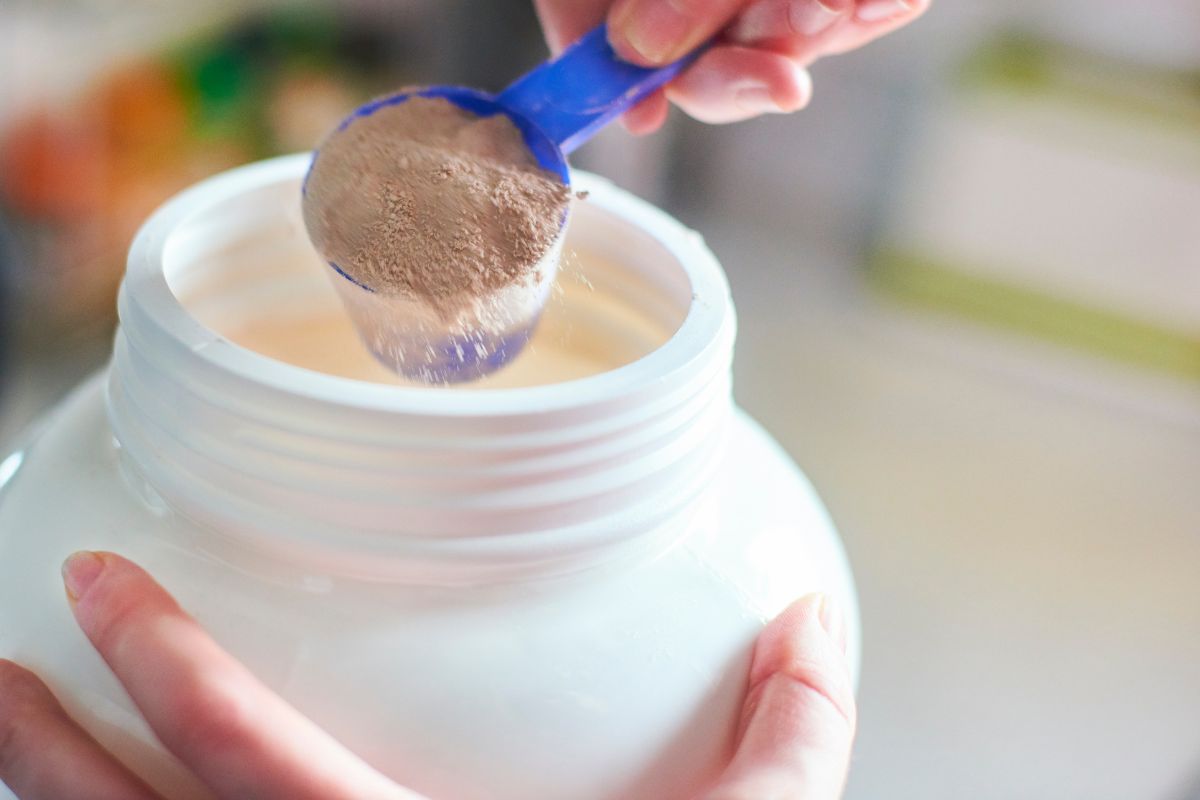 Scooping out protein powder from a container