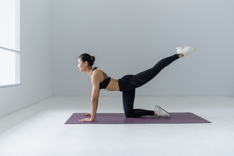 woman doing yoga on a yoga mat