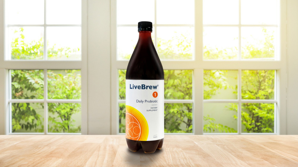 A bottle of LiveBrew® daily probiotic in front of a window