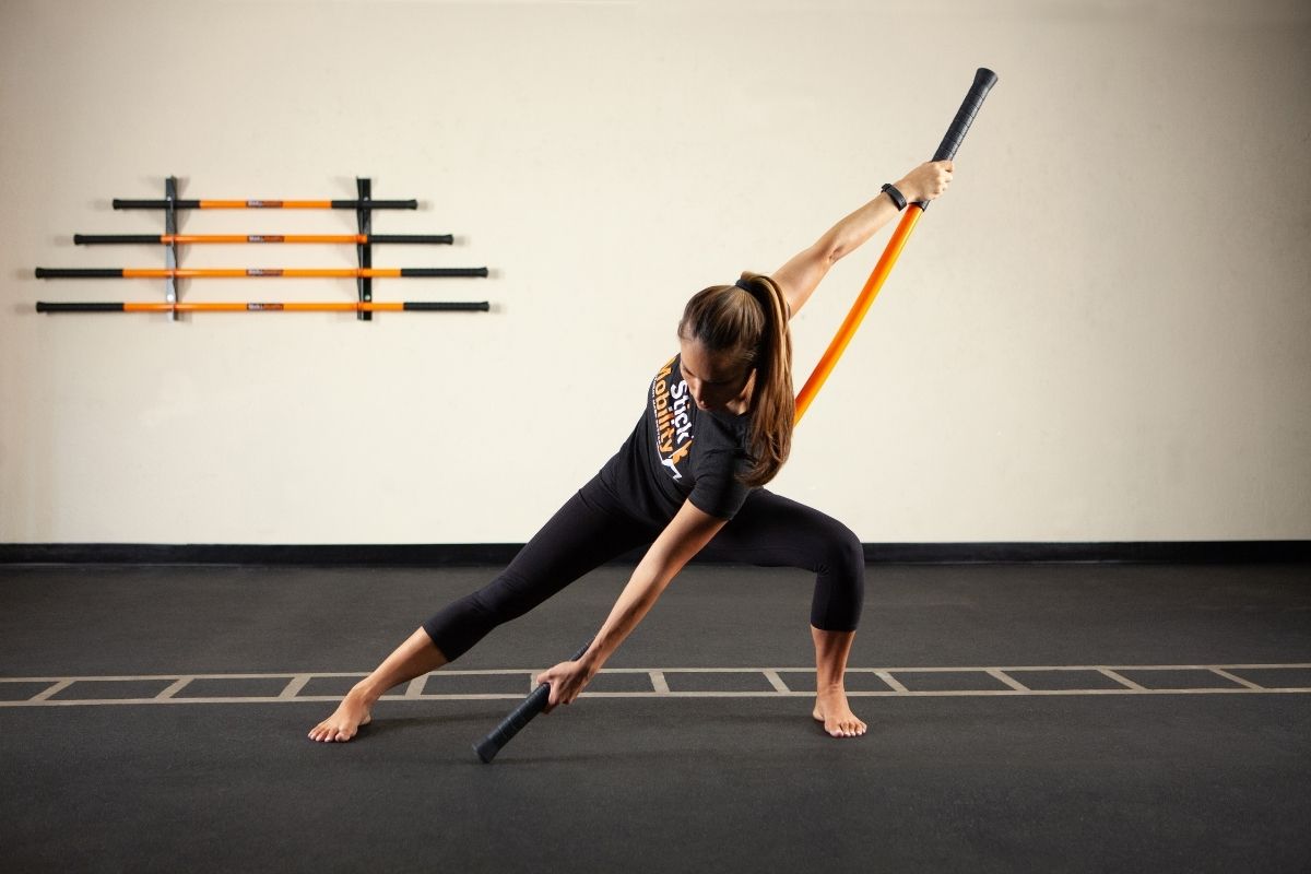 Stick Mobility being demonstrated by women in gym