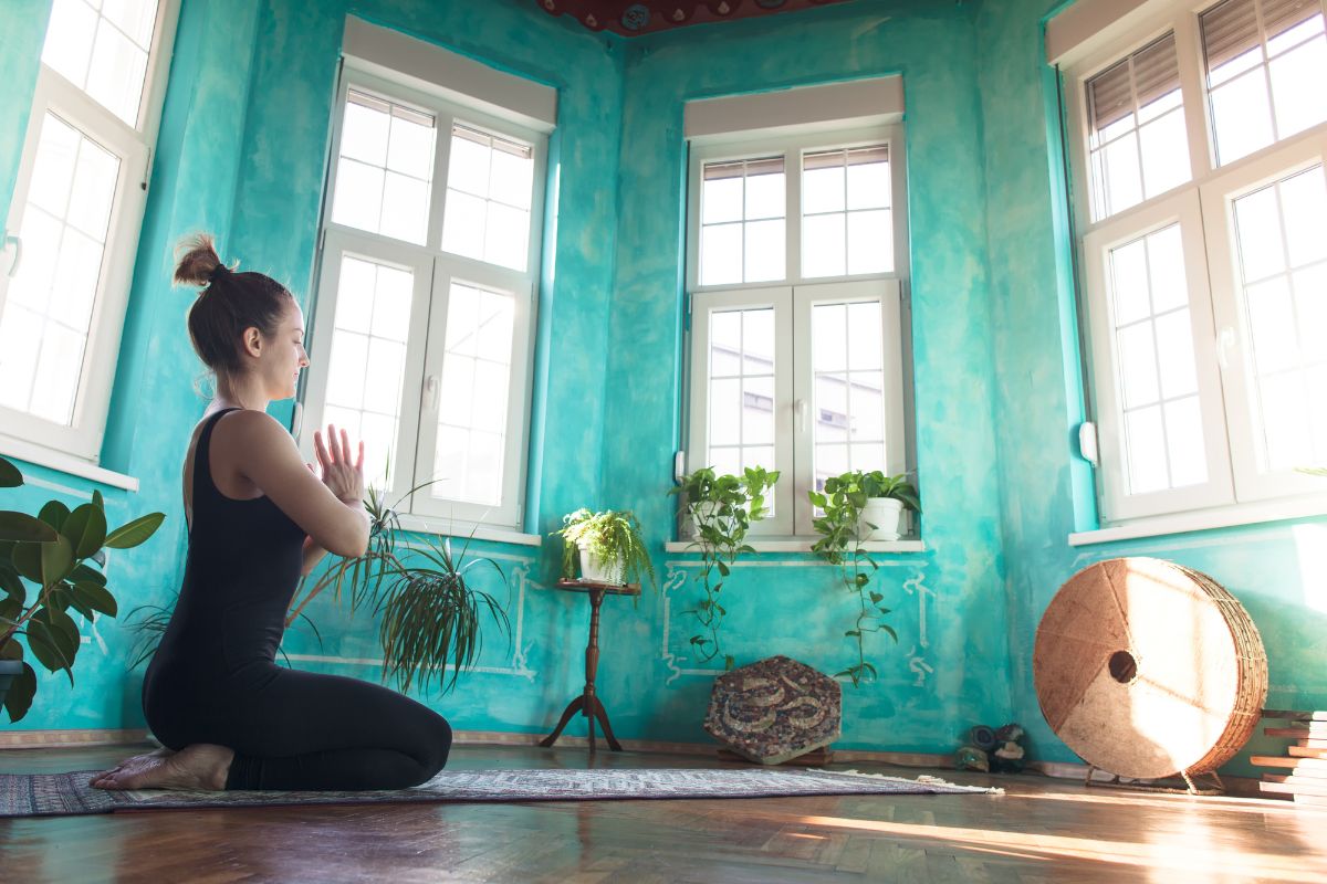 Woman doing yoga in bedroom