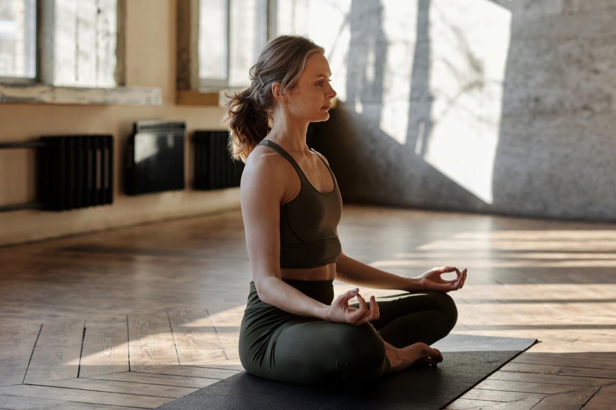 women meditating on yoga mat